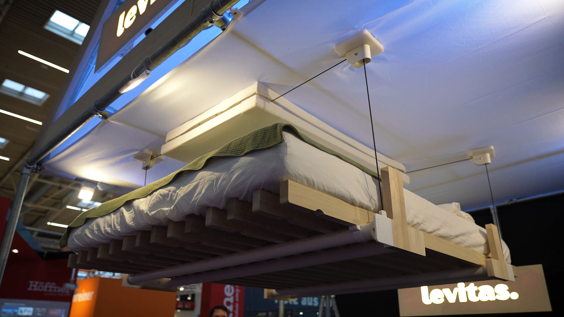 mechanism stows bed under the ceiling idael for small living spaces