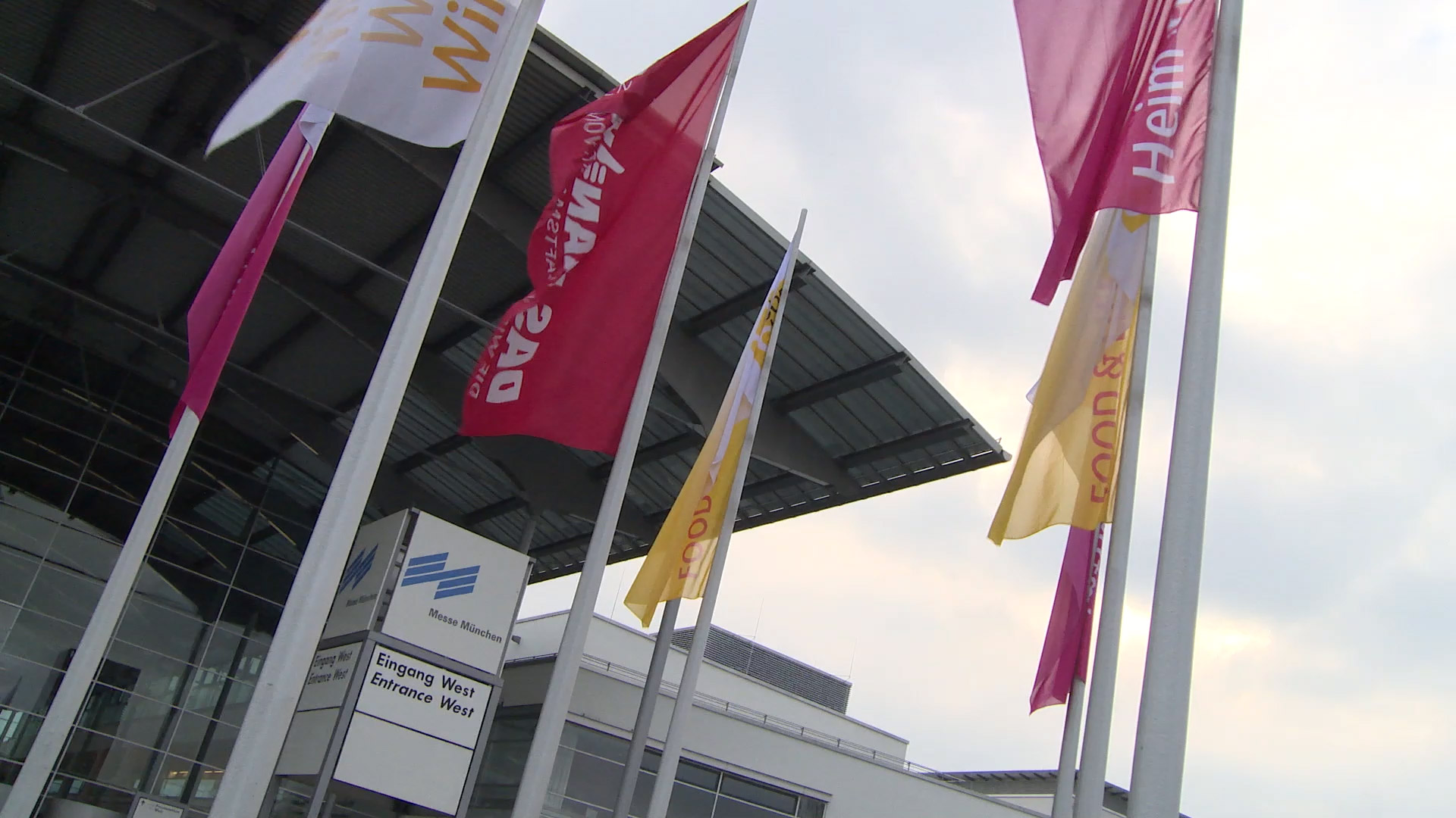 Heim und Handwerk flags fly in the entrance area of the Munich Trade Fair Center